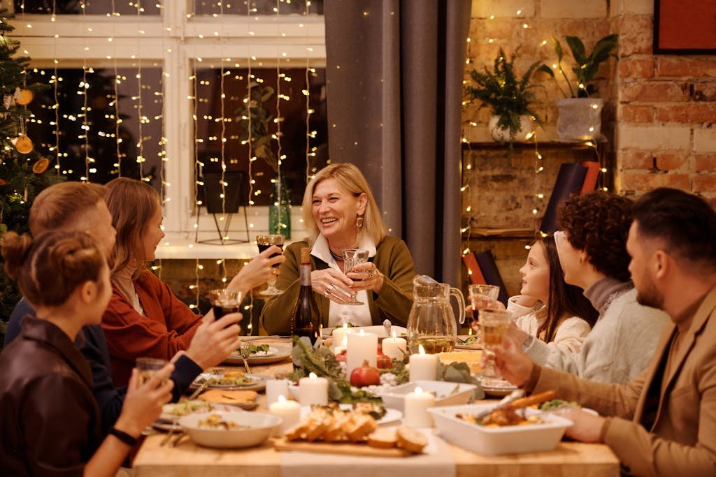 Family Having a Christmas Dinner Together. They are chatting and eating while experiencing an elegant In-Home Dining.  