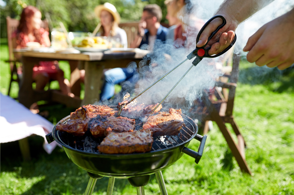 Texan BBQ party. The meat is being smoked over a grill