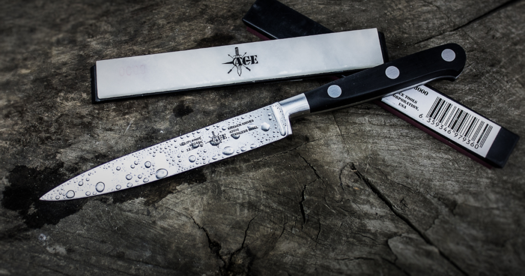 A wet stainless steal knife placed in kitchen