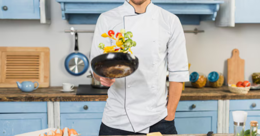 A Chef with a professional kitchen suit in the kitchen