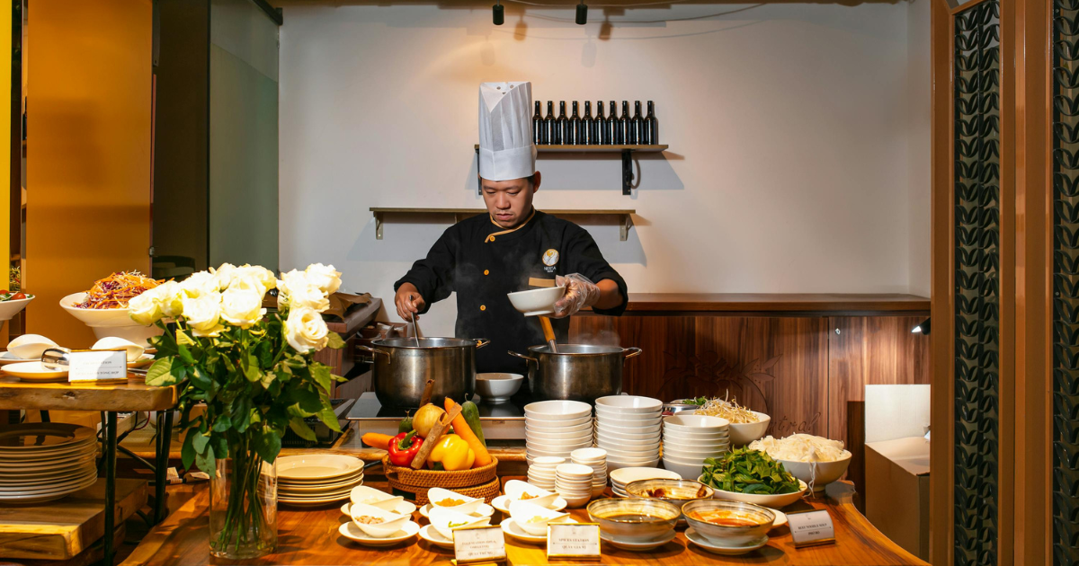 A Chef Cooking in the kitchen wearing Chef Works coat